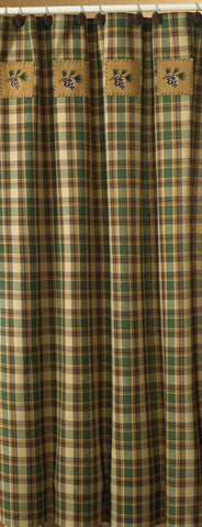 The Scotch Pine Shower Curtain features a plaid in warm shades of brown, green and dark honey with applique patches accented with embroidered pine cones.