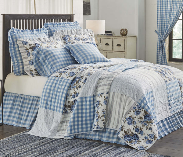 Annie Blue Floral Patch Quiltstripes, and buffalo check patchwork in a calming mixture of dusk blue, soft white, and portabella brown offers a striking yet relaxed cozy cottage feel.