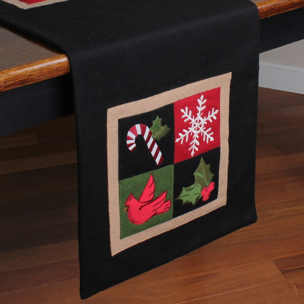 Holiday Motif Christmas table runner with cardinal, candy cane, holly, and snowflake appliques on a black background.