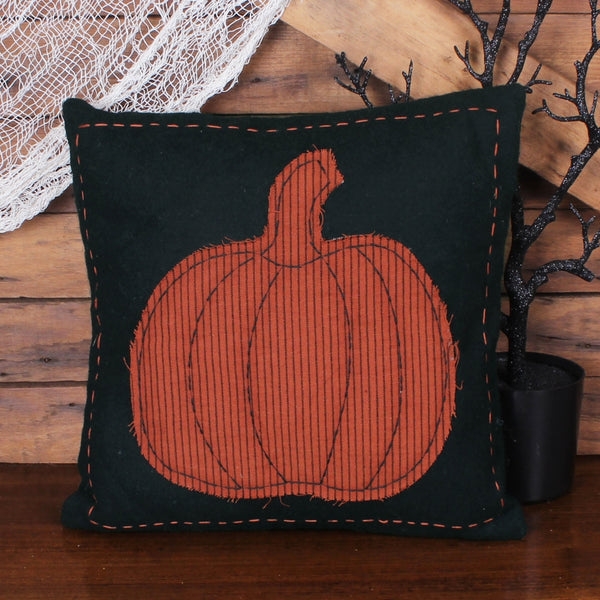 Primitive black fall pillow with orange striped pumpkin appliqué and decorative stitching