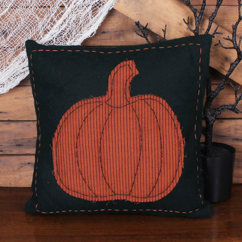 Primitive black fall pillow with orange striped pumpkin appliqué and decorative stitching