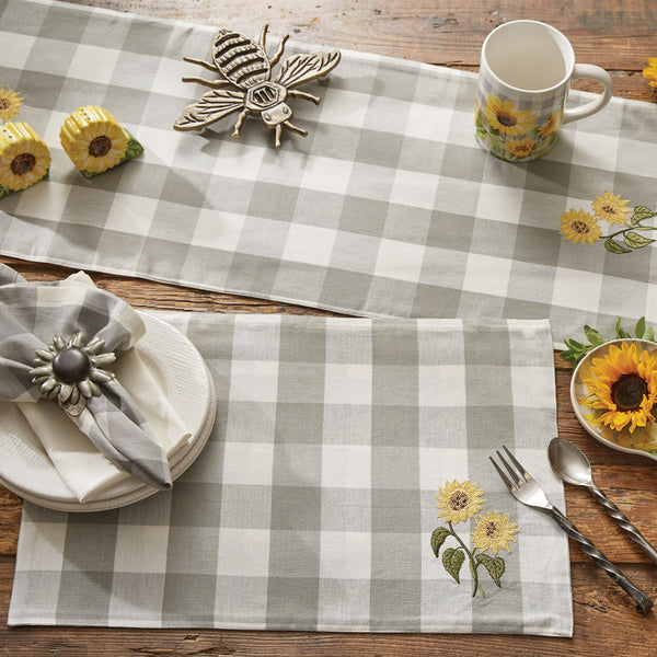 Check out these striking Wicklow Check Sunflower Embroidered Placemats! Paired with the rest of the collection, the beautiful dove gray and white large checks are certain to make a statement in any kitchen decor!