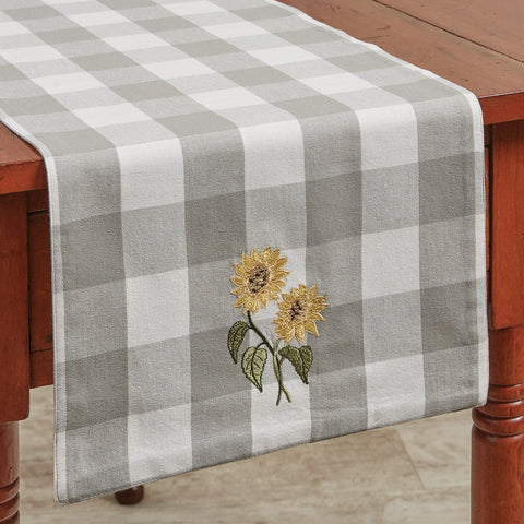 Check out these striking Wicklow Check Sunflower Embroidered Table Runner! Paired with the rest of the collection, the beautiful dove gray and white large checks are certain to make a statement in any kitchen decor!