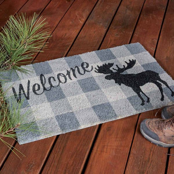 Our Welcome Moose Doormat will be a wonderful addition to your entryway. Featuring a gray and white checkered background and a black moose silhouette with the message Welcome.  Made from all-natural fibers and hand painted sentiment in colorfast dyes, this doormat is durable and skid resistant. It will be the perfect addition to your decor that can be used year after year.