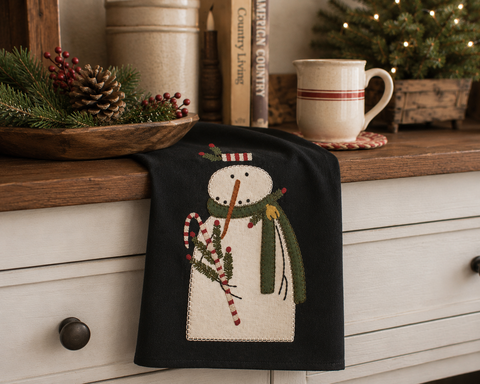 Mr. Winterberry Christmas towel featuring a snowman with greenery, berries, and candy cane accents on a black background.