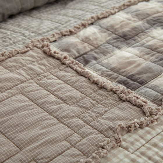 Smoky Cobblestone Throw has a  a series of soft, woven plaids in fresh neutral colors such as taupe, ivory, slate and dove grey help to make this an instant classic. The fabrics are arranged in large offset panels with geometric quilting for a contemporary touch. Our coordinating quilted shams, pillows and valance carry this theme throughout your room.