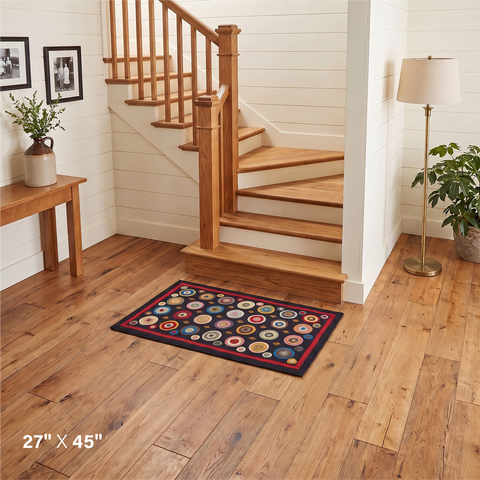 Coin Multicolor Primitive Wool Felt Accent Rug 27x45 with colorful circular motifs on black in a country home