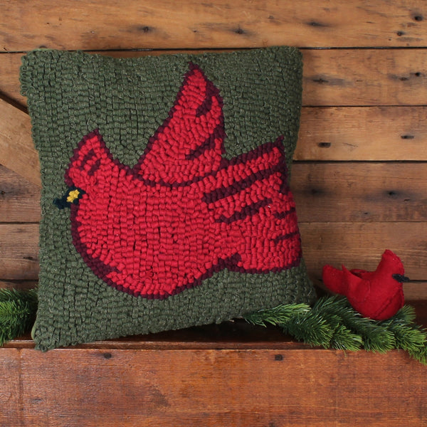 Cardinal Hooked Pillow featuring a vibrant red cardinal on a rich green hooked wool background.