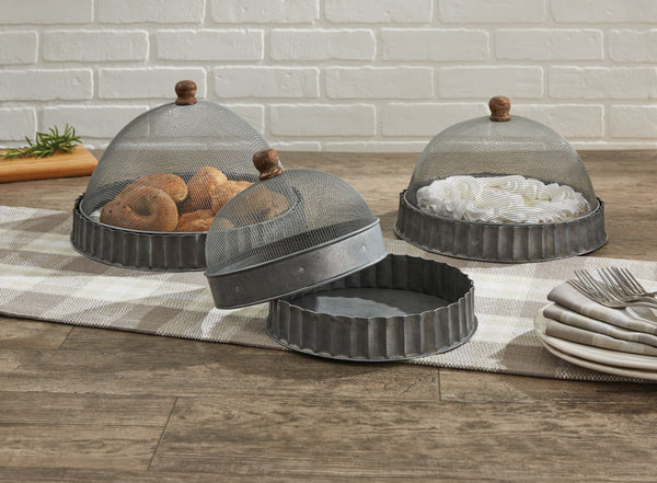 Great indoors or outdoors! The<span>&nbsp;</span><strong>Covington Screened Covers with Bases Set</strong><strong>, </strong>reminiscent of corrugated metal, includes three different sized fluted galvanized tin bases with matching screening covers to keep food pest-free.