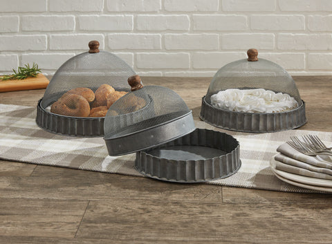 Great indoors or outdoors! The<span>&nbsp;</span><strong>Covington Screened Covers with Bases Set</strong><strong>, </strong>reminiscent of corrugated metal, includes three different sized fluted galvanized tin bases with matching screening covers to keep food pest-free.