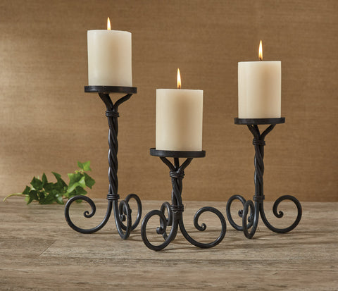 Constructed of iron & featuring a scrolled, twisted effect, these candle holders offer a timeless beauty that will surely complement any decor!  Dimensions: 5"H, 7"H and 10"H Set of 3 Pillar candles sold separately