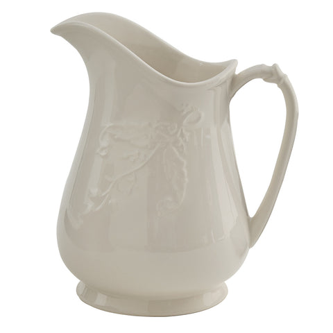 With gently curving vintage style and floral accents, this stunning candlelight white Stoneware Pitcher will beautifully accent any country table. Pictured on right with Stoneware Milk Pitcher.