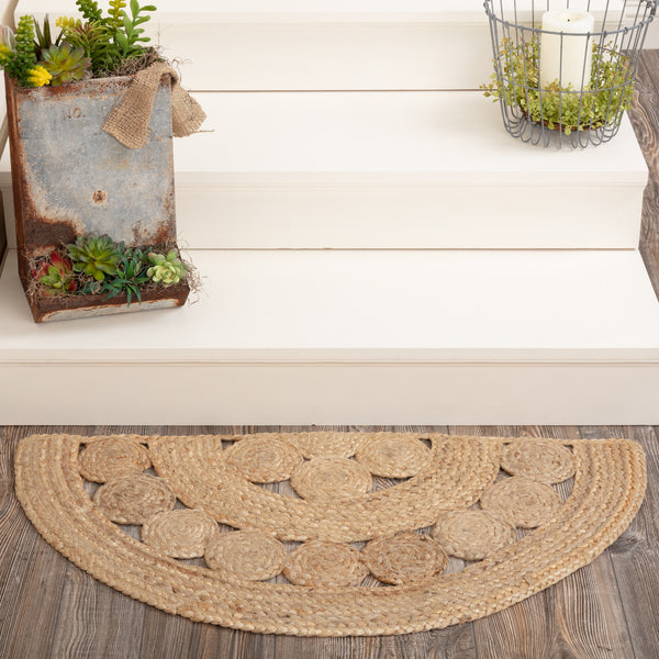 Create a warm, homey feeling in entryways or kitchens with natural tones in pure Jute that add style anywhere a small accent rug is needed. The Celeste Jute Rug measures 16.5x33 inches and features a classic half circle shape and tight braids constructed with 100% Jute. Features alternating rows of solid braids and small jute circles for a natural, rustic look that complements a wide array of farmhouse decor with rich texture and classic country charm.