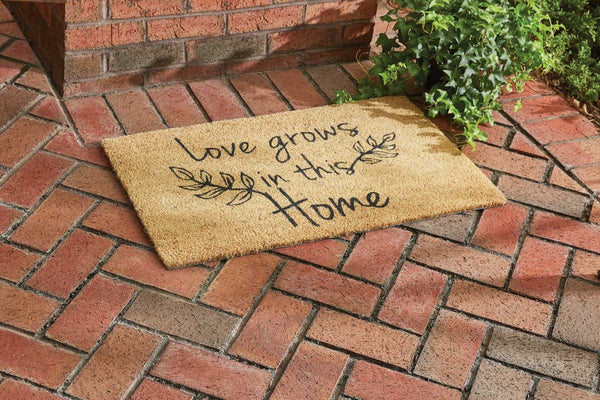 Our Love Grows Doormat features leaves and the message Love Grows in This Home