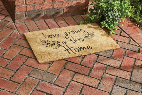 Our Love Grows Doormat features leaves and the message Love Grows in This Home