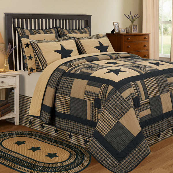 Add a primitive touch to your bedroom decor with deep, classic country tones of soft black and khaki tan. The Black Check Star California King Quilt includes one 130x115-inch quilt. The primitive country bedding features patchwork details with prominent five-point stars and confetti strip blocks surrounded by a solid and checked plaid border. The quilt is machine washable and iron safe and crafted in 100 percent cotton for a soft feel and durable wear. It reverses to solid tan. Coordinates with the Black Ch