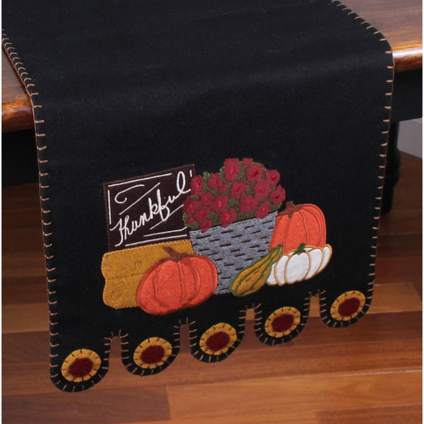 Primitive black wool felt table runner featuring pumpkins, gourds, sunflowers, and Farmers Market appliqué accents.