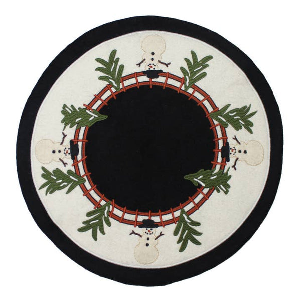 Home For The Holidays Candle Mat featuring embroidered snowmen, evergreen branches, and a rustic wreath design on wool felt for Christmas decorating.
