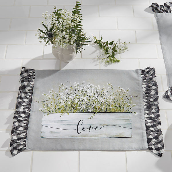 Bouquet Of Grace Placemat, features a gray background with a beautiful basket of flowers and the word "love", accented by a black and white ruffled check bord