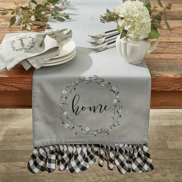 Accent your country-inspired home decor with the Bouquet Of Grace Table Runner! The runner features a dove gray background with two beautiful circles of flowers (family, home), accented by a black and white ruffled border!