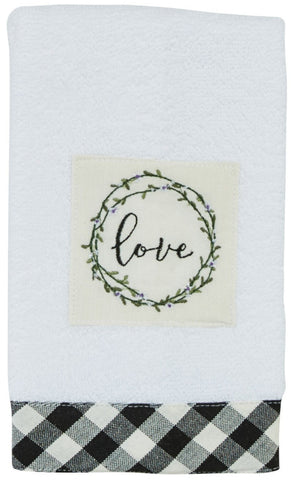 Bouquet Of Grace Terry Fingertip Towel features a soft, neutral white color that is accented by a black & white checked border. The wording "love" with the circle of flowers gives it added style & grace! 