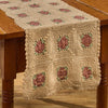 Granny Square 13x54 crochet table runner in cream with muted rose and sage green floral squares on a rustic wood table