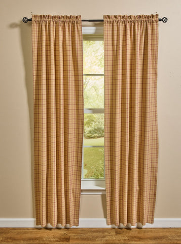 Persimmon lined primitive country plaid curtain panels hanging in a farmhouse window