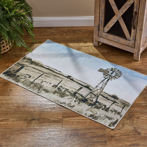 Windmill washable accent rug with soft farmhouse landscape design on a rustic wood floor