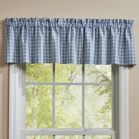 Blue and cream Stafford Dusk primitive farmhouse window valance displayed over a country style window.