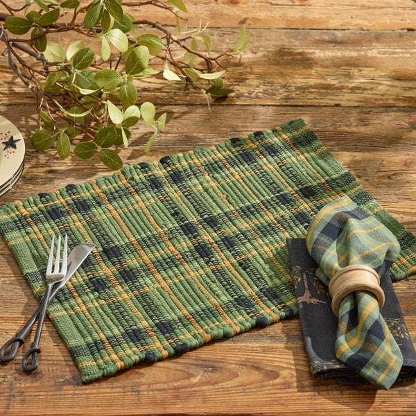 Bring rustic texture to your dining table with the Willow Lane Chindi Placemat Set of 4. Handwoven plaid in green, gold, and black for farmhouse charm.
