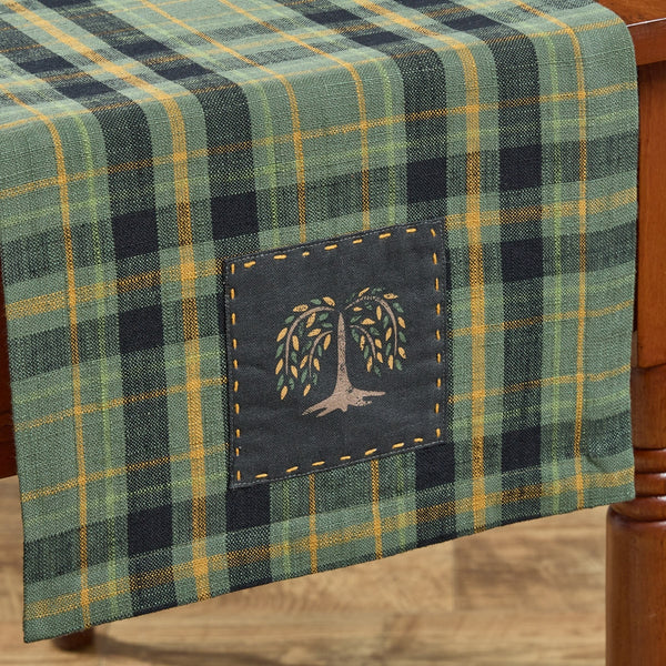 Add farmhouse charm with the Willow Lane Plaid Table Runner 13x36. Classic green, gold & black plaid design brings rustic primitive style to any table.