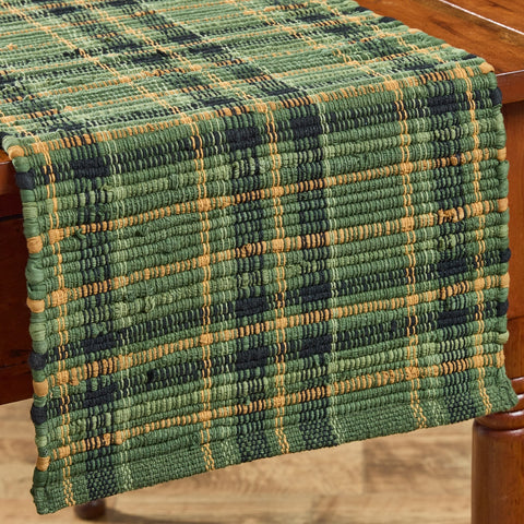 Add rustic farmhouse charm with the Willow Lane Chindi Table Runner 13x54. Handwoven plaid in green, gold, and black brings warmth to your dining table.