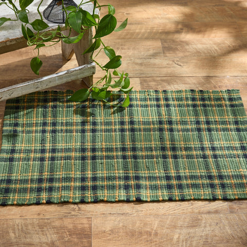 Bring farmhouse charm home with the Willow Lane Rag Rug 2x3. Plaid in green, gold, and black, this handwoven cotton rug adds warmth and rustic style to any space.
