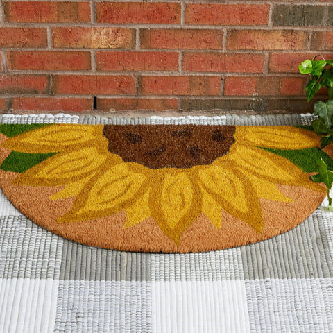 Our Backyard Beauties Doormat will liven up your entryway and add warm welcome to your home.  In a half circle shape this doormat features a large sunflower.
