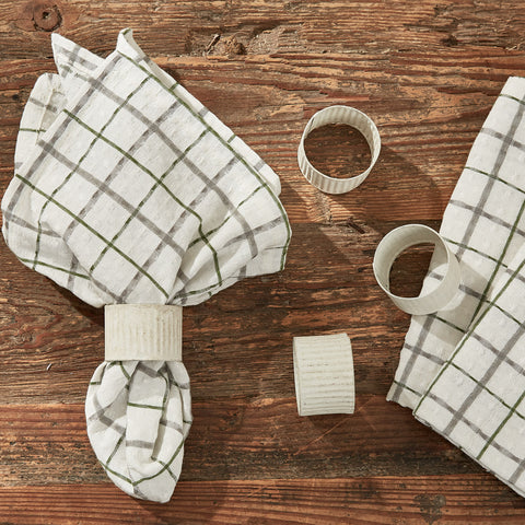 The windowpane plaid in these<span>&nbsp;</span><strong>Kindred Napkins</strong><span> </span>is sure to project a classic country farmhouse flair, with the lovely shades of candlelight white, dove gray, and briarwood green! Check out the matching placemats and table runners (sold separately)!