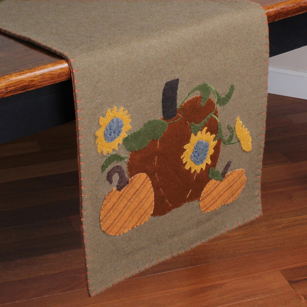 Primitive tan fall table runner with orange pumpkin and yellow sunflower wool appliqués
