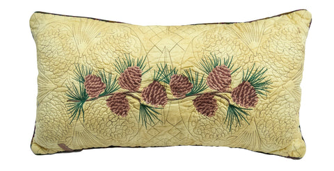 Cabin Raising Pinecone Rectangle Pillow with embroidered pinecones and pine needles on a tan background.