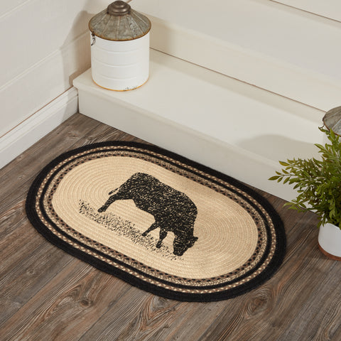 <p>The Sawyer Mill Charcoal Cow Jute Rug makes a textured farmhouse addition to your home decor. This little area rug showcases beautiful concentric braids of a variety of colors with a solid colored center. A weathered grazing cow silhouette is stenciled in black on this oval rug adding a little barnyard charm to your floor.&nbsp;</p> <h4></h4>