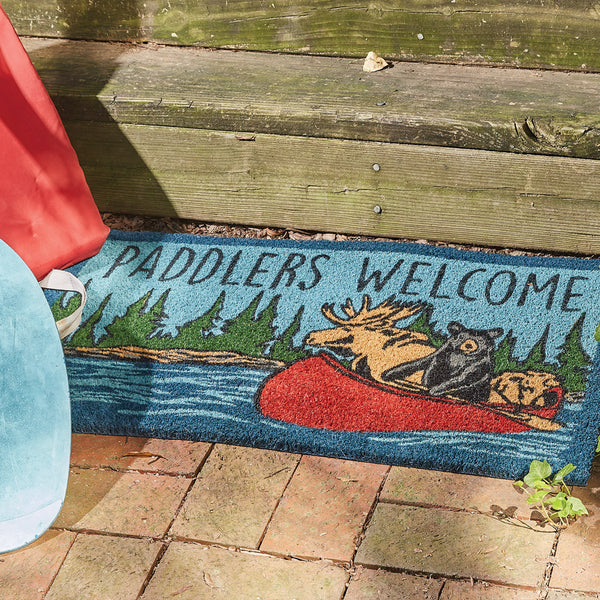 Our Summer Vacation Doormat will liven up your entryway and add warm welcome to your home.  Features woodland animals floating in a canoe and the words Paddlers Welcome.
