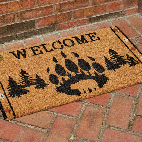 Our Wild Woods Doormat will liven up your entryway and add warm welcome to your home.  Features a bear claw and silhouette with pine trees and the word Welcome.