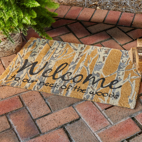 Add charming style to your floor with the Refined Rustic Doormat! Featuring a tree trunk design in tones of white and gray with a message in black, Welcome To Our Neck Of The Woods. This doormat will be an elegant touch to your country decor! Complete the look with the rest of the Refined Rustic collection!