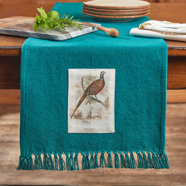 The Pheasant Run Patch Table Runner adds a charming touch to your country table! Featuring a charming bird perched on a branch in the wilderness, this table runner will be a stylish accent to your decor! Coordinate with the matching Pheasant Run Dishtowels and Pheasant Run Valance!