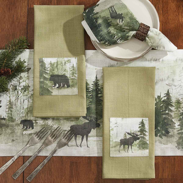 This Watercolor Moose Dishtowel offers a beautiful outdoorsy appeal! Featuring a muted blend of grays and greens that work together to create a scene of a moose in its natural habitat on a dark sage towel, these dishtowels are sure to bring the rugged outdoors in! Pair with the coordinating pillow, doormat, valance, table runner, and napkins for a complete look!