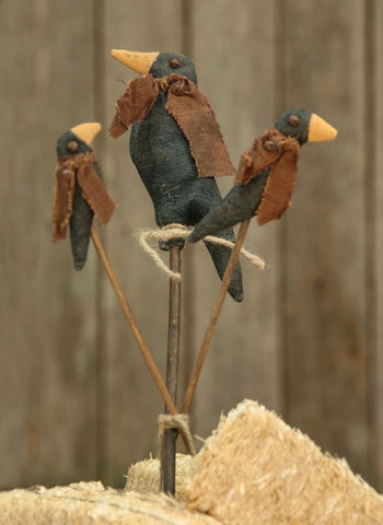  Crow Family Stakes features three stakes, each with a different-sized stuffed crow atop it. The stakes are held together with a jute tie and the tallest measures 15" high.