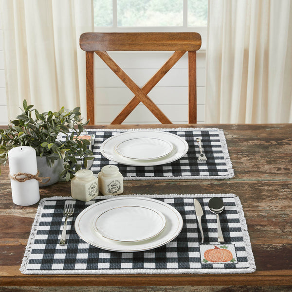 Create the perfect table settings with a country casual feel accented with subtle fall flair. The Annie Black Check Pumpkin Placemat Set includes two placemats measuring 13x19 inches each. The table place settings features buffalo check fabric with a classic burnt orange pumpkin design in the lower right corner of each mat.