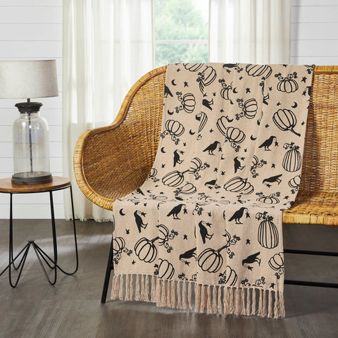 Warm, primitive style gets a spooky season makeover with a charming print featuring pumpkins and ravens on a field of stars and crescent moons. The Raven Harvest Throw measures 50x60 inches and is crafted with recycled cotton in a natural tan color. The fall throw blanket is edged with long tassels that perfectly frame a bold fall pattern in black. Machine washable and iron safe.