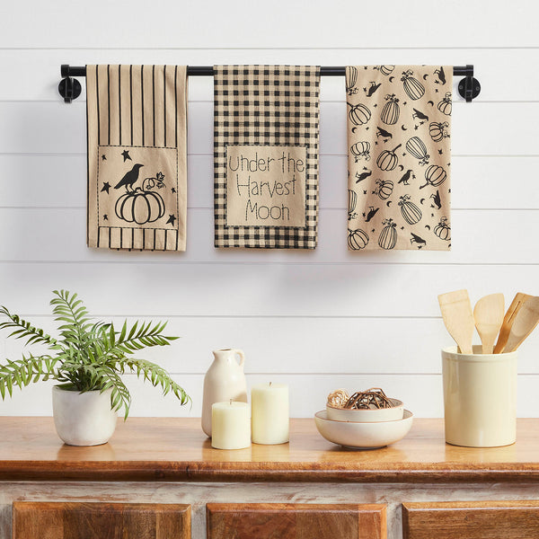  The checkered tea towel includes word art reading, Under the Harvest Moon while the striped towel is adorned with a small scene featuring a raven sitting atop a large pumpkin. Machine washable and iron safe. This primitive design is great for both fall and Halloween decor.