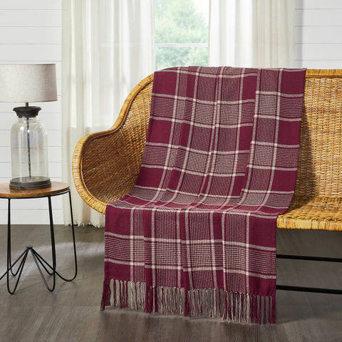Deep burgundy and natural tan create a traditional tartan plaid for updated fall style. The Eston Burgundy Tan Plaid Throw measures 50x60 inches and features a deep red base with natural tan striping.