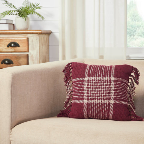 Add dramatic fall style to your home with bold, dark color and traditional plaid. The Eston Burgundy Tan Plaid Pillow measures 12x12 inches and is constructed with recycled cotton and a cotton polyester blend. The throw pillow features a deep red base with dark tan striping in a tartan plaid pattern. Exaggerated tassels create a unique look. Spot clean as needed.