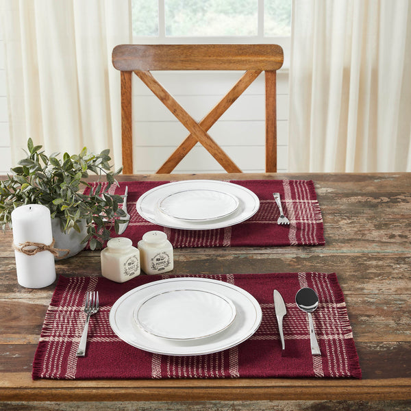 Create the perfect table settings with a timeless feel. The Eston Burgundy Tan Plaid Placemat Set includes two placemats measuring 13x19 inches each. The table place settings are constructed with a single layer of a cotton polyester blend and includes a fringed edge. The deep red base features deep tan stripes in a traditional tartan plaid pattern.
